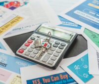 Calculator sits on various colored papers on a table