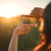 Hands forming a square frame gesture while capturing the setting sun, symbolizing a clear vision and future focus.