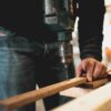 person drilling wood