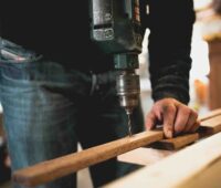 person drilling wood