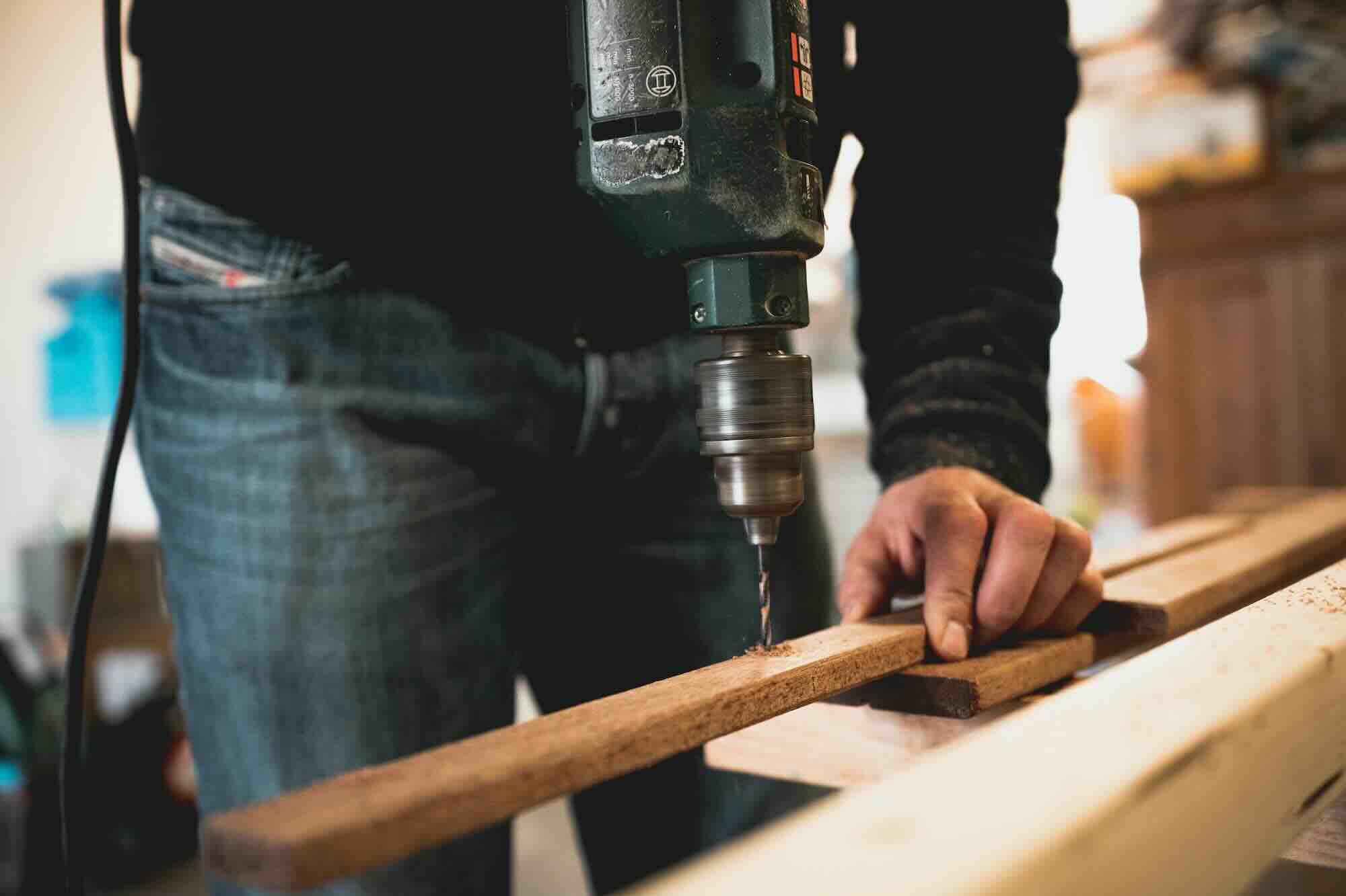 person drilling wood