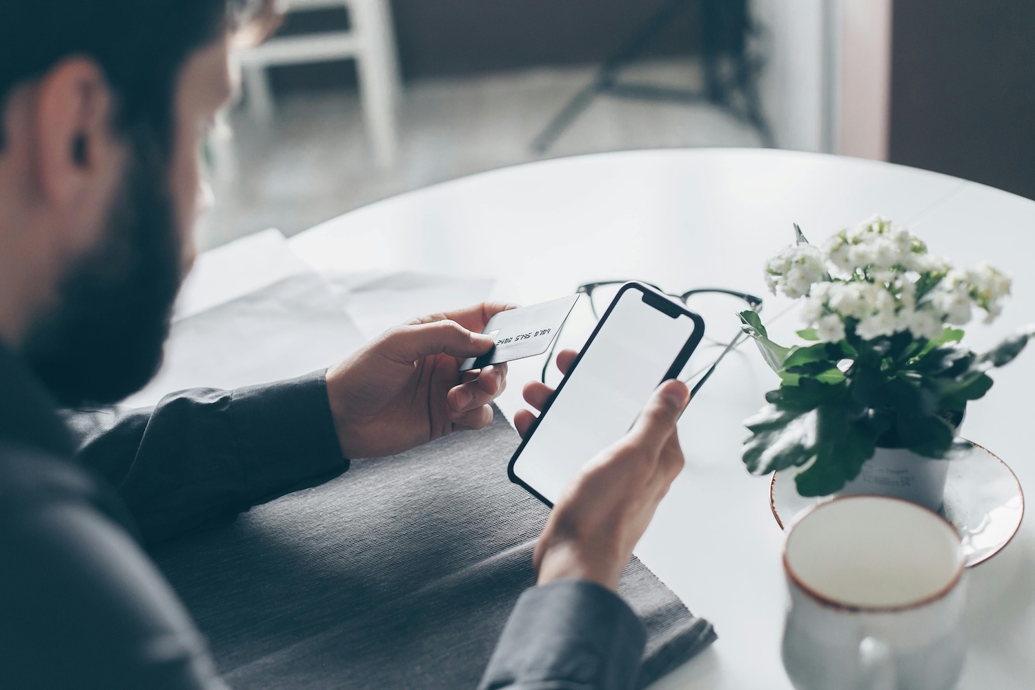 Man holding credit card and phone in hands