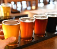 Flight of glasses of beer, ale, porter or stout for a craft beer tasting at a brewery.