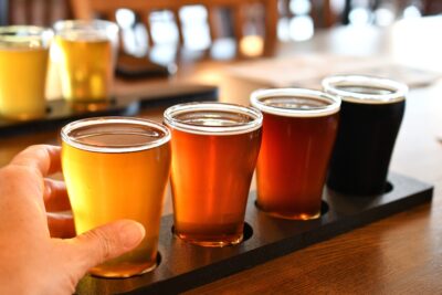 Flight of glasses of beer, ale, porter or stout for a craft beer tasting at a brewery.