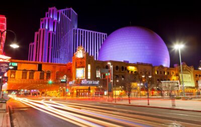 Downtown Reno Nevada hotels at night with traffic trails.