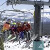 Family of four sitting on a Tahoe Donner ski lift