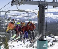 Family of four sitting on a Tahoe Donner ski lift