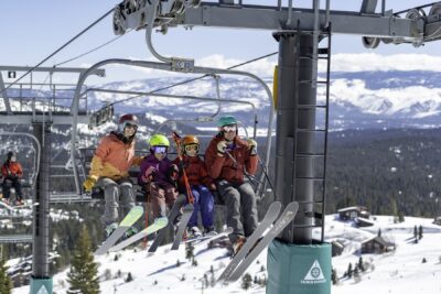 Family of four sitting on a Tahoe Donner ski lift