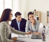 Couple meeting real estate agent to get home buying advice